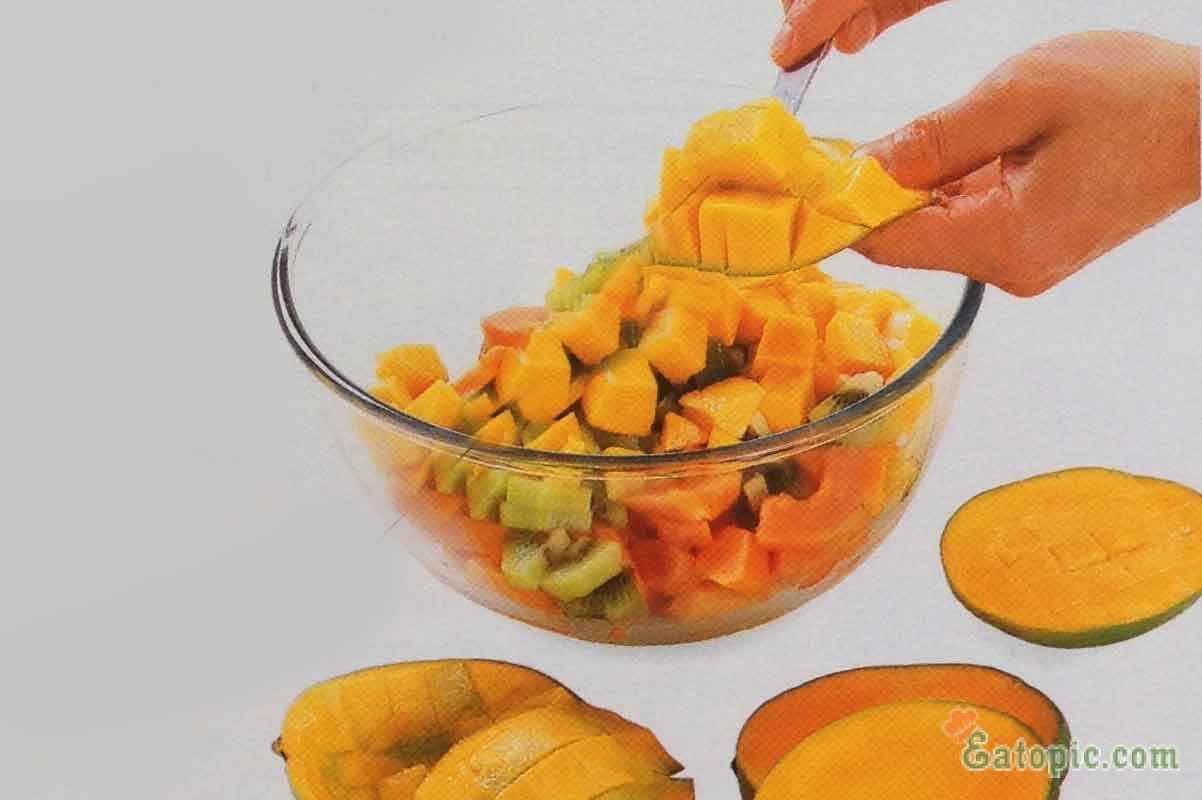 Cut 2 large mangoes lengthwise into 2 pieces