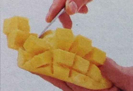 Holding the mango flesh upwards