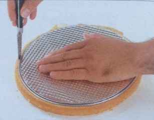 Trim the cake rounds to fit the Springform tin, using the base of the tin as a guide.